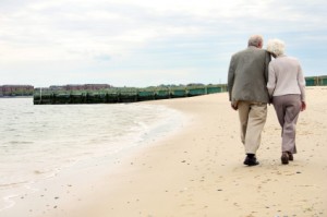 OLD COUPLE WALKING ON BEACH